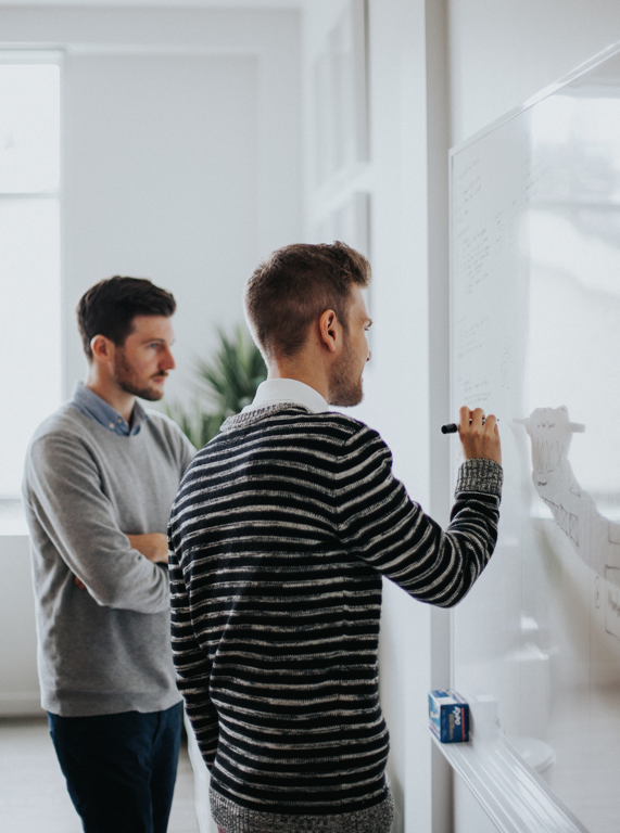 two men making a brainstorm on whiteboard